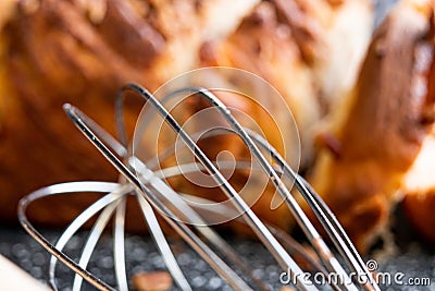 Kitchen manual mixer on black table dusted with flour in close up Stock Photo